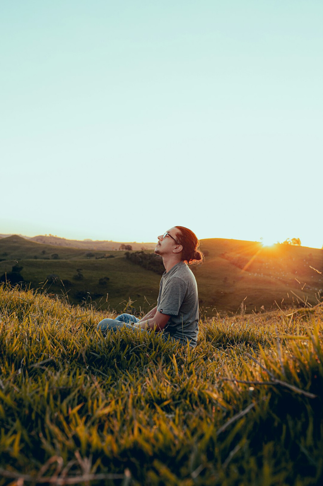 Woman meditating calmly outdoors at sunrise