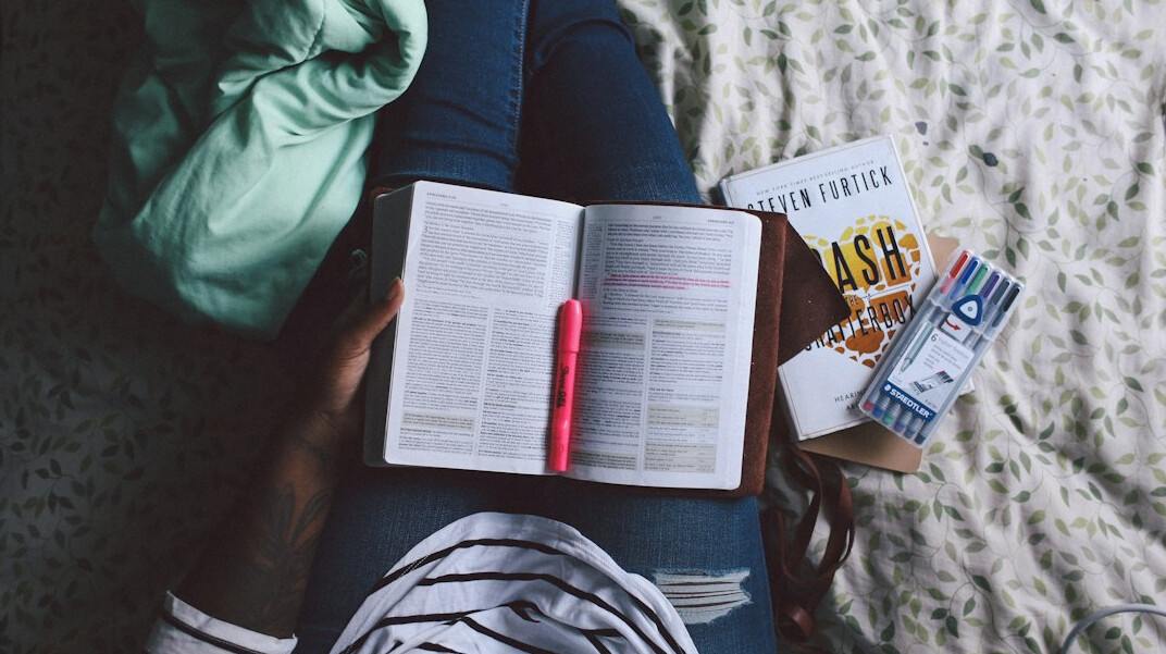 Person studying with an open notebook and books